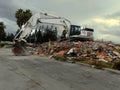 Building being demolished by a powerful excavator Royalty Free Stock Photo