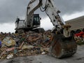 Building being demolished by a powerful excavator Royalty Free Stock Photo