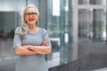 Older business woman CEO standing and smiling confident, successful, at office building with copy space Royalty Free Stock Photo