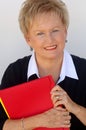 Older business woman with file folders