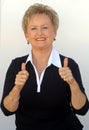 Older business woman thumbs up