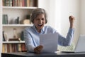Older businesswoman read documents, screams with joy, celebrate great news