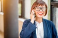 Older businesswoman talking phone indoors Royalty Free Stock Photo