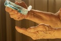 Older caucasian woman applying alcohol gel cleaning hands to helping protect from coronavirus covid-19
