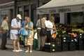 Older couple buys fruit in a shop, city Porto