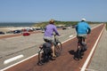 Older couple cycling on Brouwersdam, Netherlands