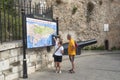 Older couple looking at large tourist map of Gibraltar. Royalty Free Stock Photo