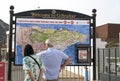 Older couple looking at large tourist map of Gibraltar. Royalty Free Stock Photo