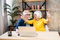 Older couple looks on laptop with a winery smiles Royalty Free Stock Photo