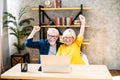 Older couple looks on laptop with a winery smiles Royalty Free Stock Photo