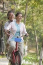 Older couple riding tandem bicycle, Beijing