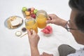 Older couple toasting with fresh orange juice while enjoying a breakfast picnic Royalty Free Stock Photo