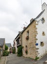 Older couple walks through the narrow streets of an idyllic French village Royalty Free Stock Photo