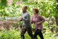 Older couple wearing sportswear and running in forest at mounta Royalty Free Stock Photo