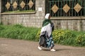 An older Ethiopian woman walking on the streets of Addis