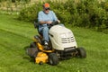 Older Gentleman Cutting Grass On Riding Lawnmower Royalty Free Stock Photo