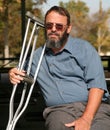 Older gentleman holding crutches Royalty Free Stock Photo