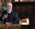 Older gentleman in suit with glass of wine
