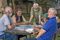 Older gentlemen play cards