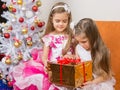 Older girl gives younger unwanted gift