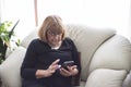 Older grandmother enjoys her smartphone