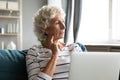 Older grandmother missing grown up children, using computer. Royalty Free Stock Photo