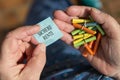 Older hands holding lottery tickets, Ticket with german text