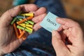 Older hands holding lottery tickets, Ticket with word Chance