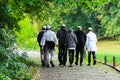 Older Hasidic Jews walk in the park during the Jewish New Year in Uman, Ukraine. Religious Jew