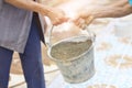 Older Labor or workers carrying construction sand for mix with cement and building houses Royalty Free Stock Photo