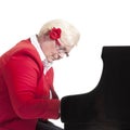 Older lady in red playing the grand piano Royalty Free Stock Photo