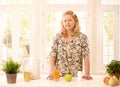 Older lady standing in kitchen Royalty Free Stock Photo