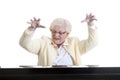 Older lady in yellow playing the piano Royalty Free Stock Photo