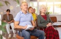 Older male and female students listening to lecture in university