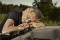 Older man alone on route checking unfunctional engine in late summer light Royalty Free Stock Photo