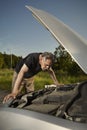 Older man alone on route checking unfunctional engine in late summer light Royalty Free Stock Photo