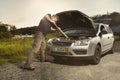 Older man alone on route checking unfunctional engine in late summer light Royalty Free Stock Photo