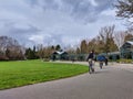 Older man biking along a bike path on a popular day at the Wilmot Gateway Riverfront Park in Woodinville