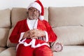 Older man dressed as Santa Claus asleep on the sofa Royalty Free Stock Photo