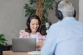 older man and female presenter in a recording studio create a podcast. senior, woman radio presenter or interviewer Royalty Free Stock Photo