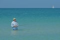 Older Man Fly Fishing in Ocean