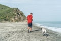 Older Man having fun with his dog on the beach in the morning Royalty Free Stock Photo