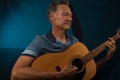 Older Man having fun playing his acoustic guitar Royalty Free Stock Photo