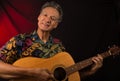 Older Man having fun playing his acoustic guitar Royalty Free Stock Photo