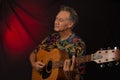 Older Man having fun playing his acoustic guitar Royalty Free Stock Photo