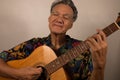 Older Man having fun playing his acoustic guitar Royalty Free Stock Photo