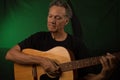 Older Man having fun playing his acoustic guitar Royalty Free Stock Photo