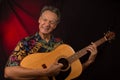 Older Man having fun playing his acoustic guitar Royalty Free Stock Photo