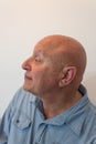 Older man head in profile, bald, alopecia, chemotherapy, cancer, on white