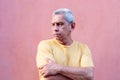 Older man leaning against a wall in the city Royalty Free Stock Photo